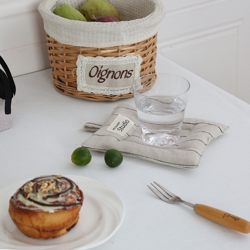 Sustainable cotton linen coasters in recyclable packaging, ideal for gifting.