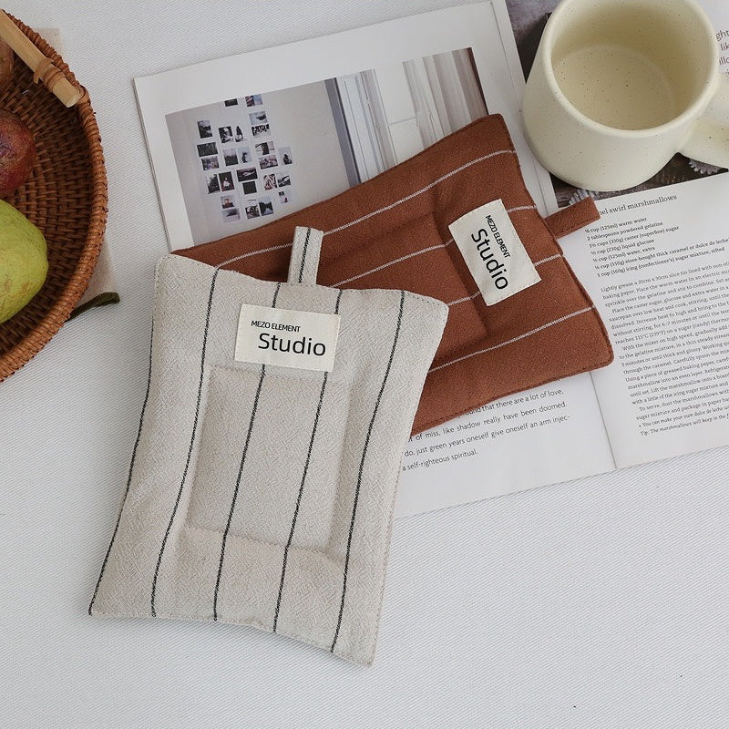 Rustic cotton linen coasters complementing modern kitchen countertop decor.