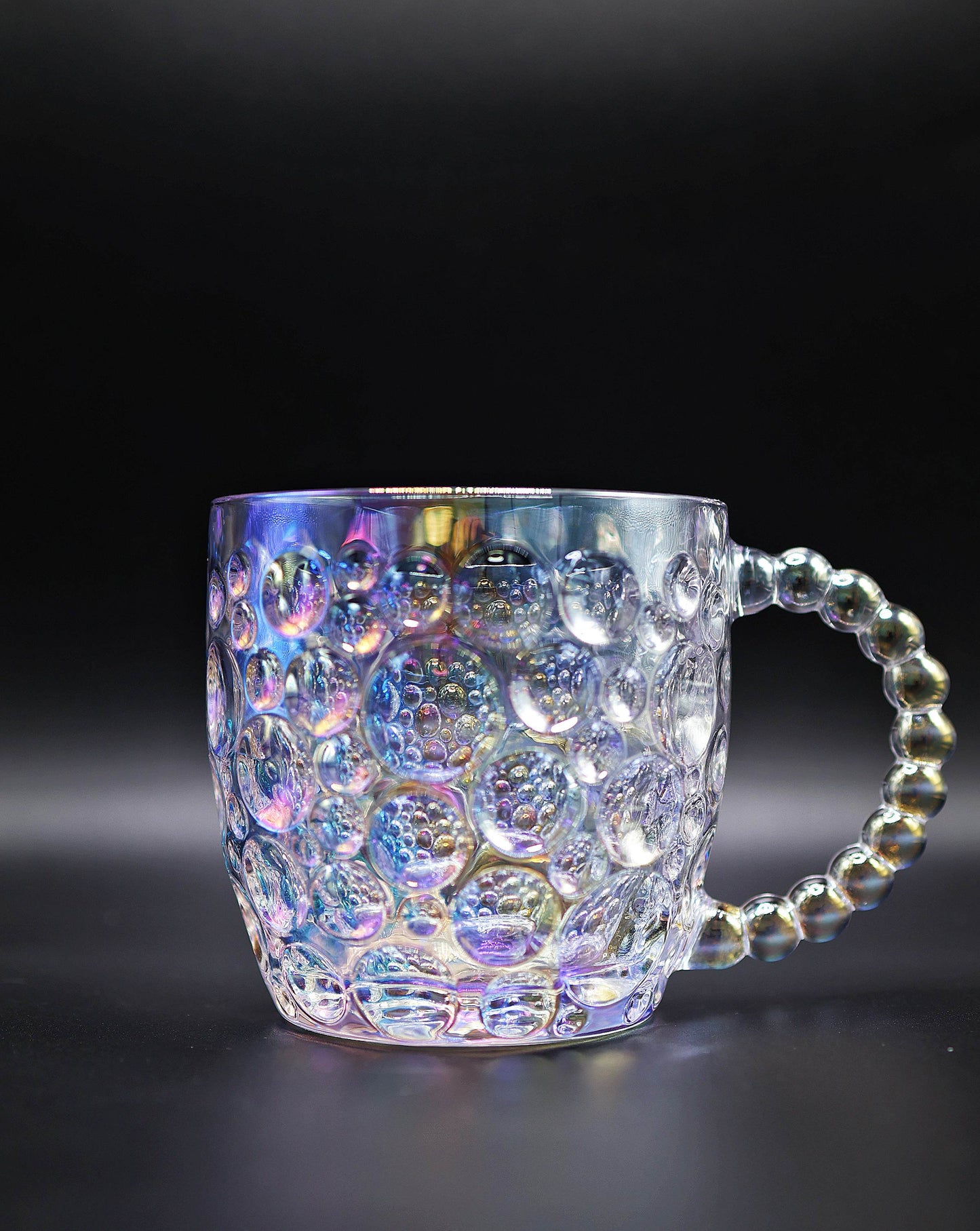 Front view of the Dreamy Luster Glass Mug with concave dot design and pearl handle.