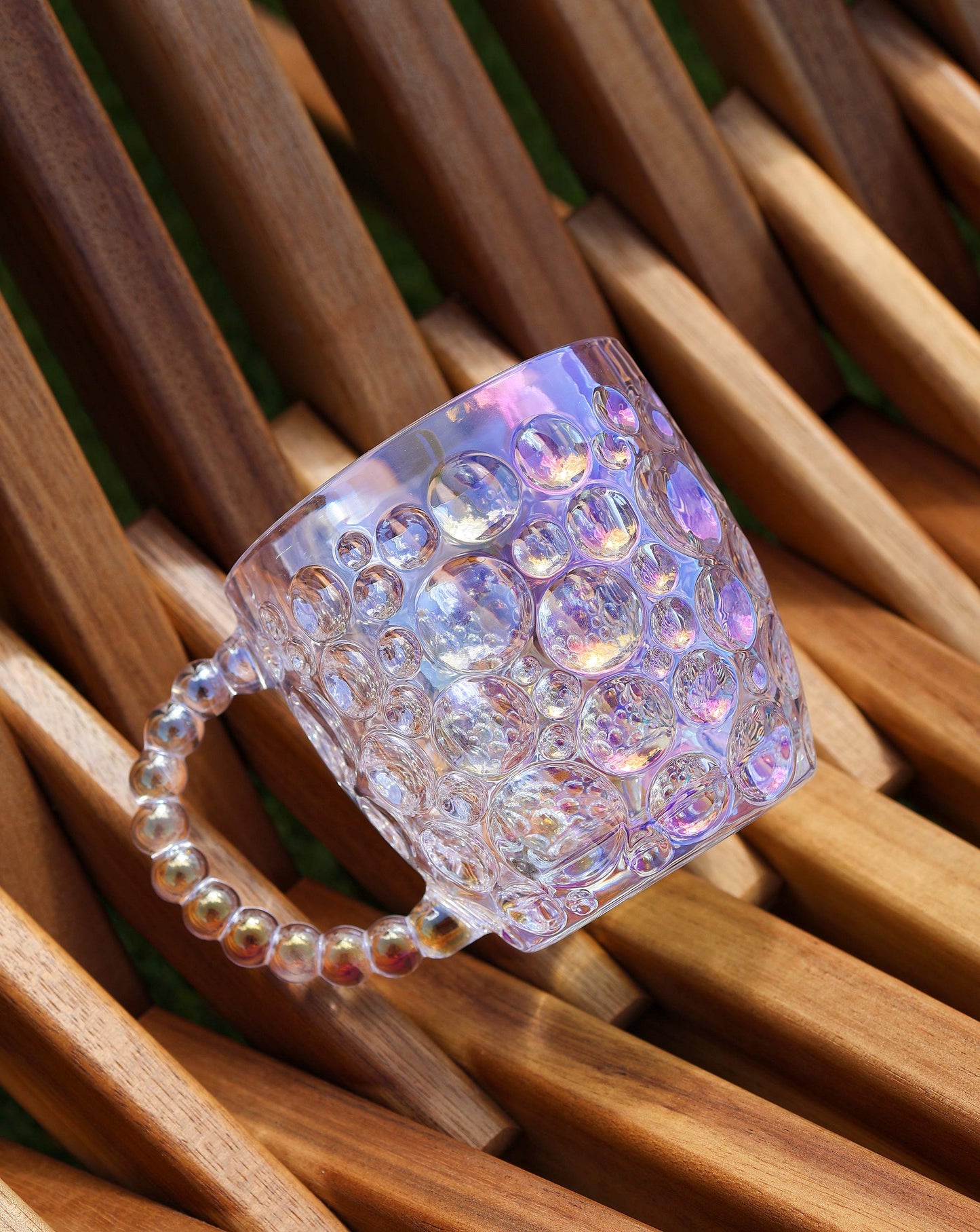 Glass mug illuminated by natural light, showcasing its lustrous finish and unique design.