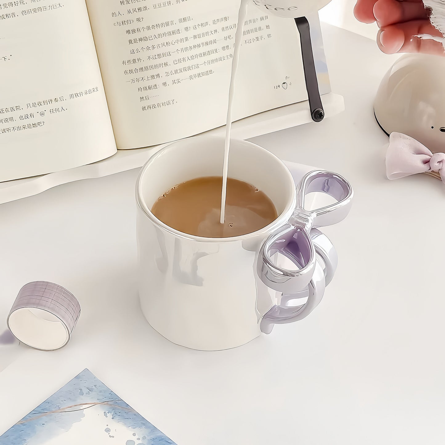 Close-up of the unique hand-sculpted ceramic bowknot detail on the mug