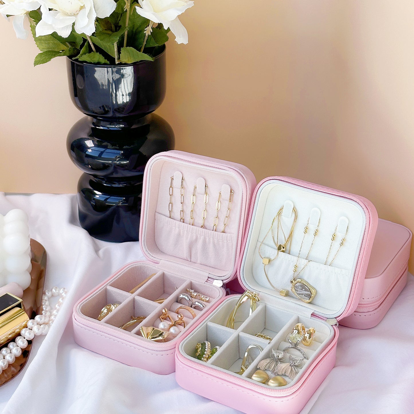 Open jewelry case showing cushioned earring slots and cross-grid bracelet storage