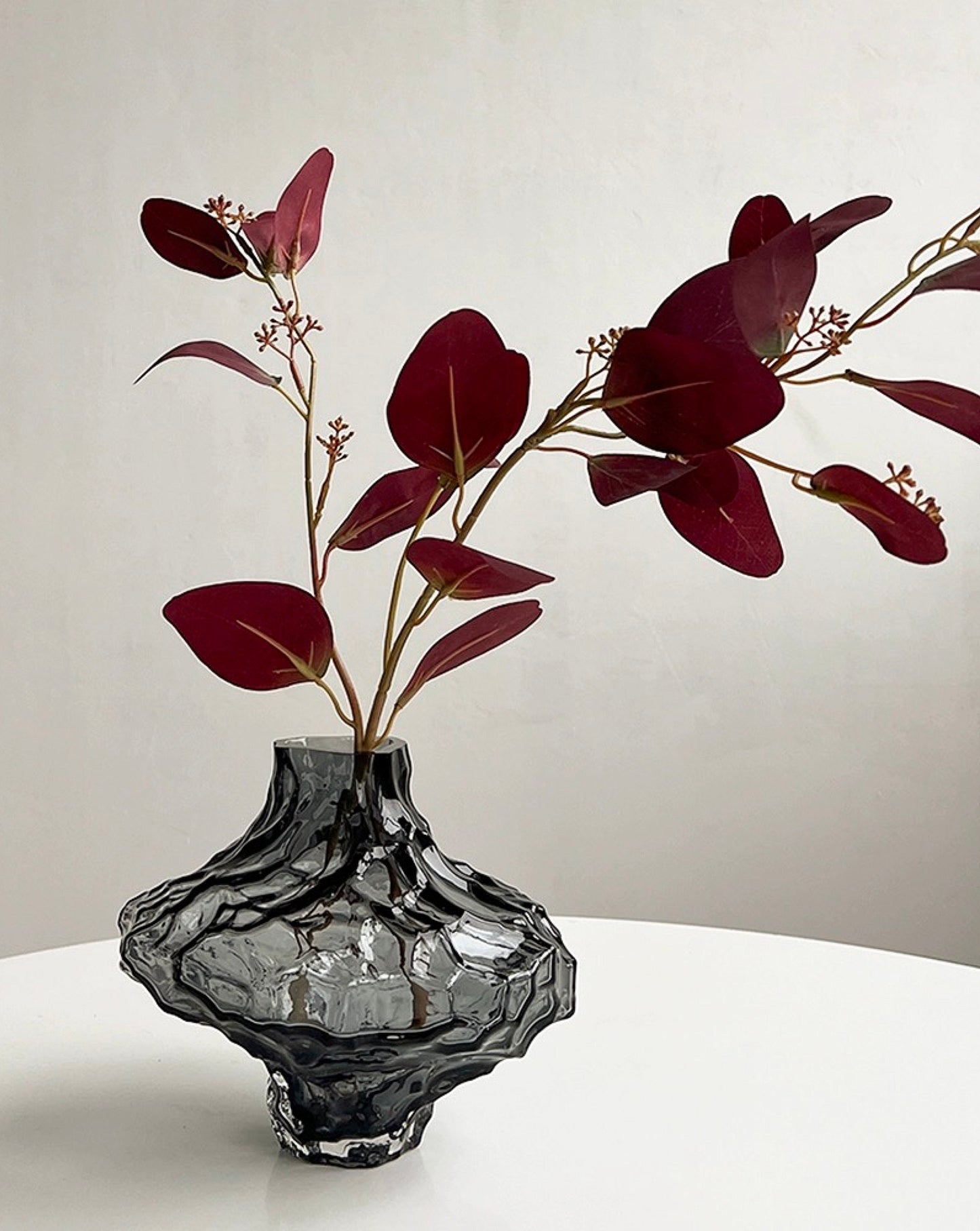 Glass vase illuminated by natural light, highlighting its organic beauty.