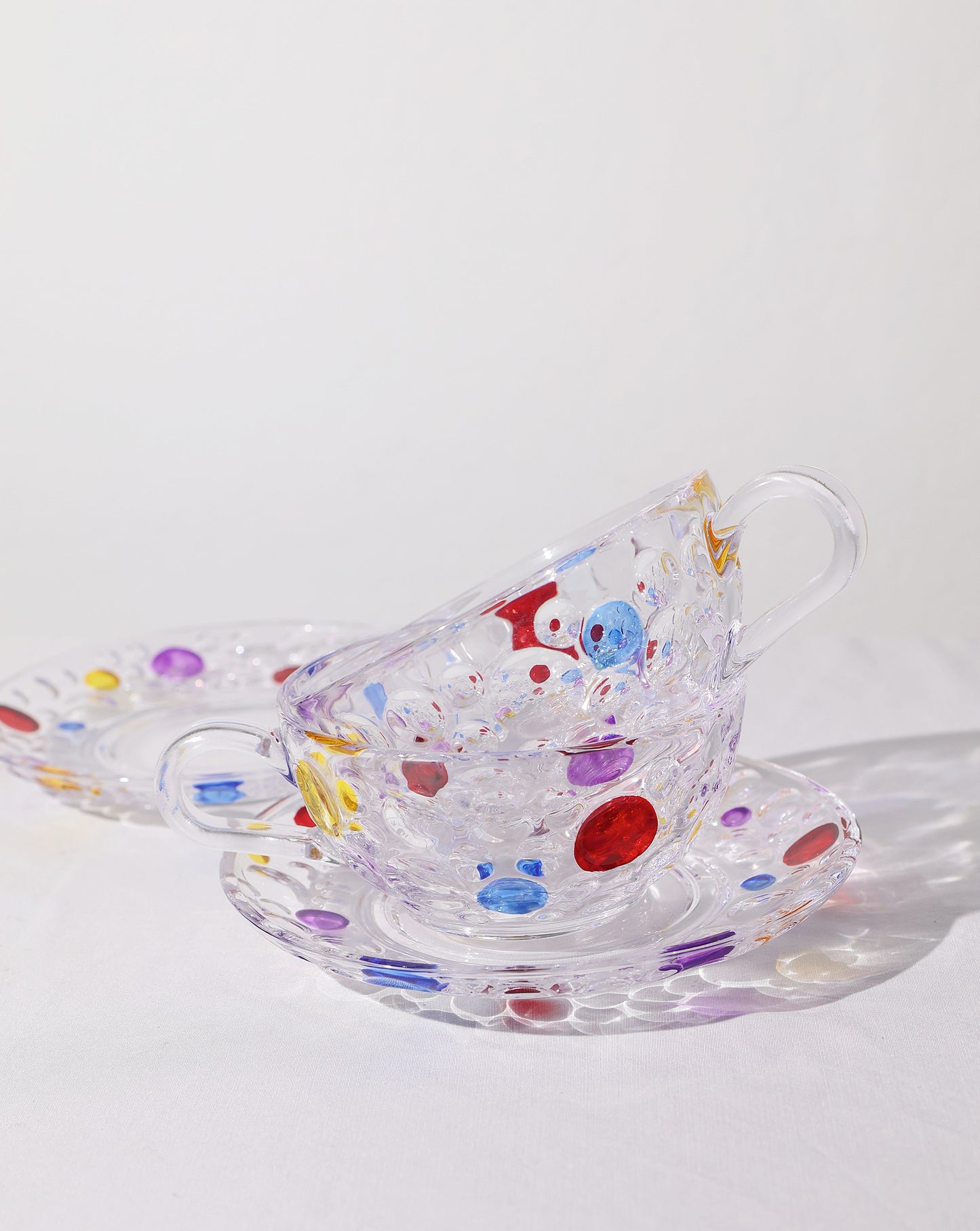 Matching saucer from the Polka Dot Cup Set, designed to complement the colorful glass cup.