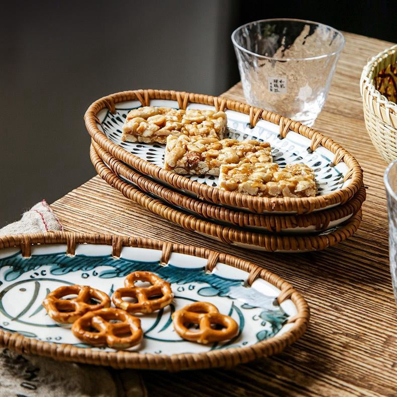 Stylish table setup featuring a rattan snack plate with tea and Asian-inspired dishes