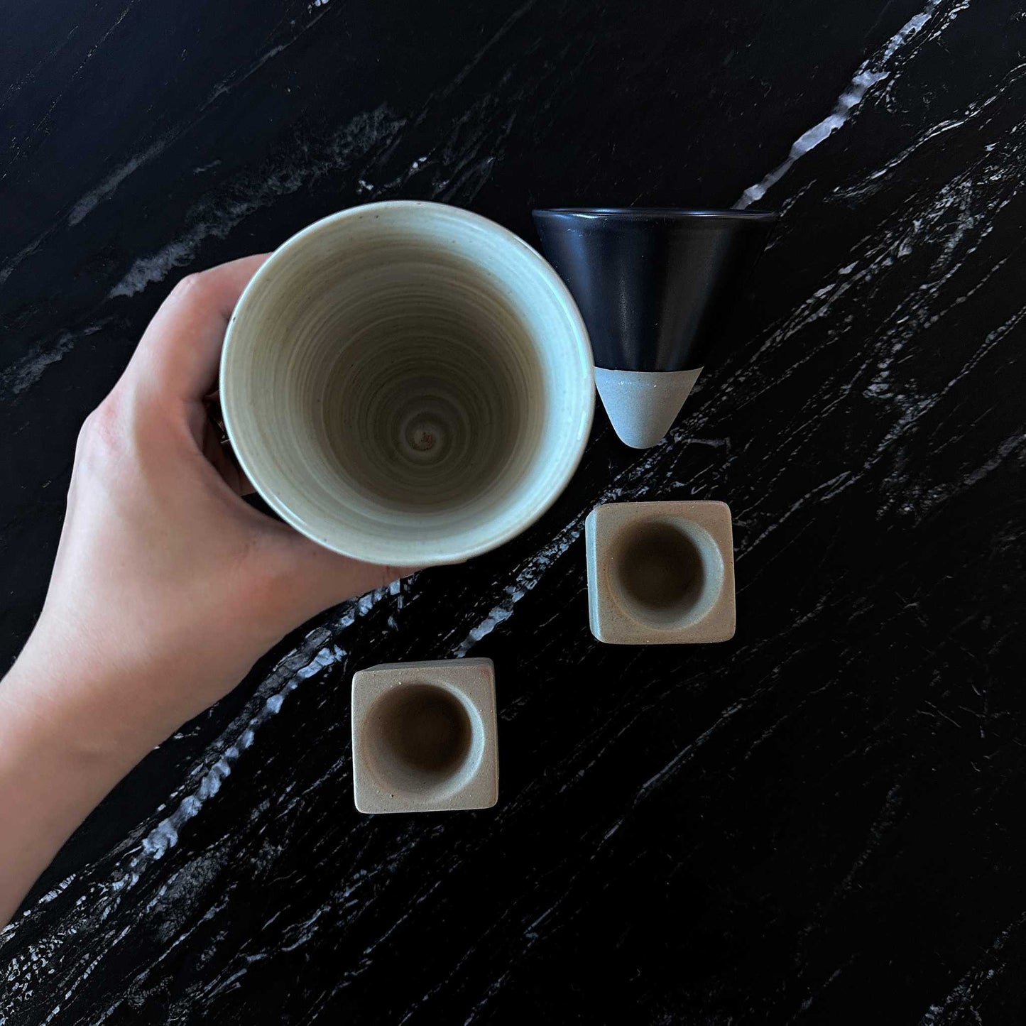 Top view of the cone-shaped ceramic cup, emphasizing its minimalist and artistic design.