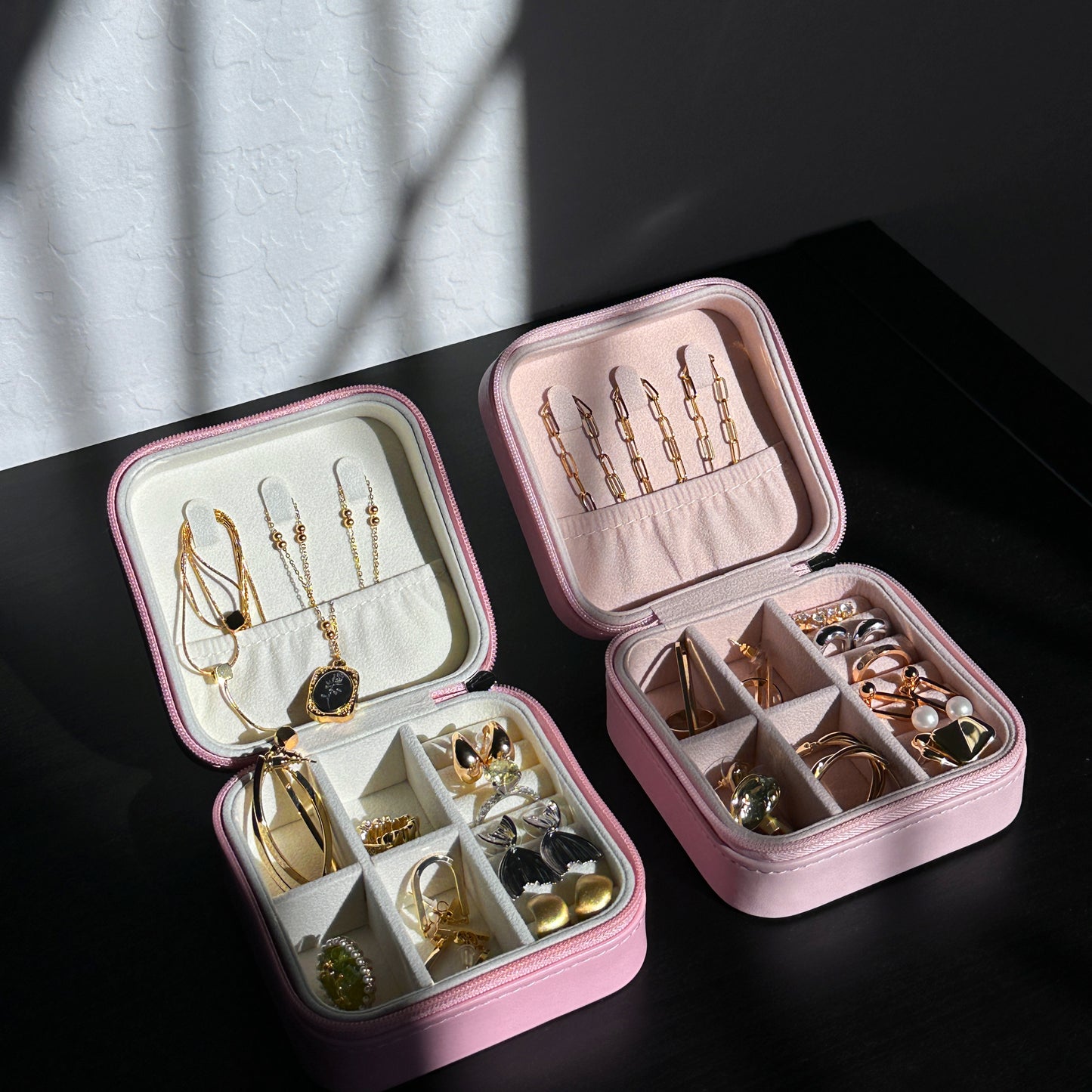 Trendy pink jewelry organizer with zippered closure, perfect for keeping valuables secure during travel