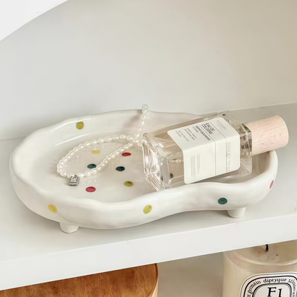 Polka dot tray as a catchall organizer for keys, glasses, and small essentials in an entryway."