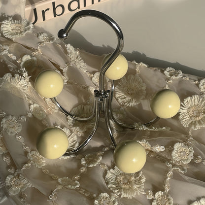 Organize your clothes and accessories effortlessly with our Sphere Rotating Closet Organizer. Featuring a sturdy metal frame, six painted wooden spheres, and a 360° rotating hook, this stylish and durable hanger is perfect for purses, scarves, hats, and more. Ideal for closets, entryways, or bedrooms, it adds elegance and convenience to any space.