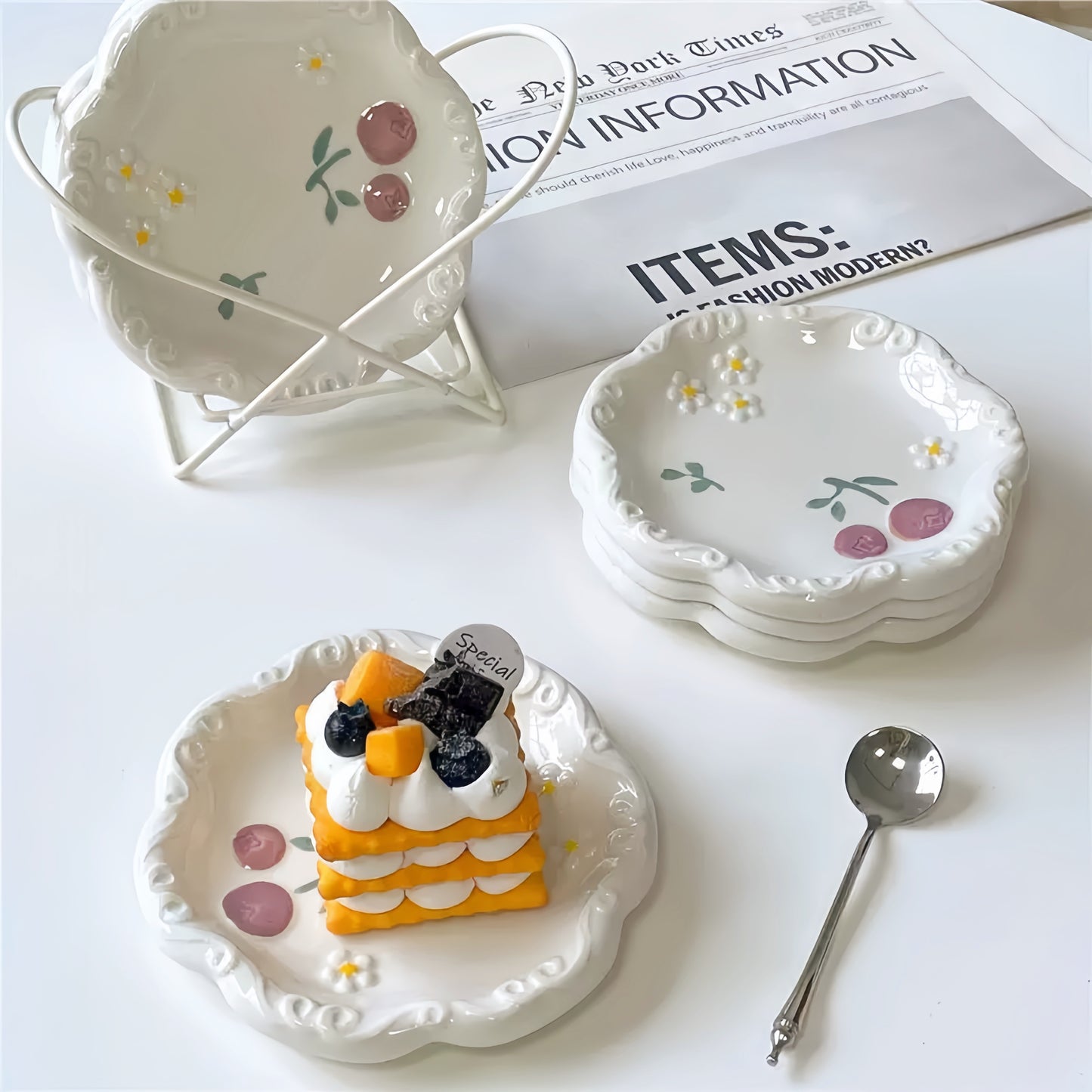 A charming afternoon tea setting featuring the daisy and blueberry plate alongside a teacup