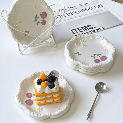 A charming afternoon tea setting featuring the daisy and blueberry plate alongside a teacup