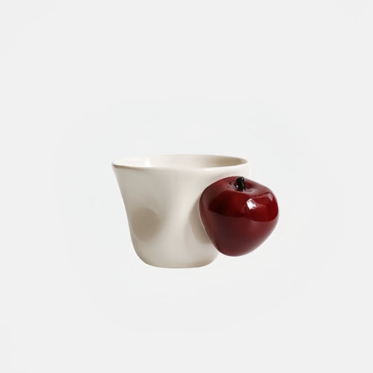 Close-up of meticulously painted whole-apple handle on CMYD Studio cup.