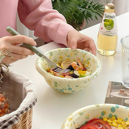 A bowl of steaming tomato soup in a microwave-safe splatter-glazed bowl, perfect for cozy meals.