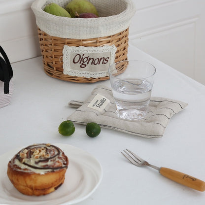 Sustainable cotton linen coasters in recyclable packaging, ideal for gifting.