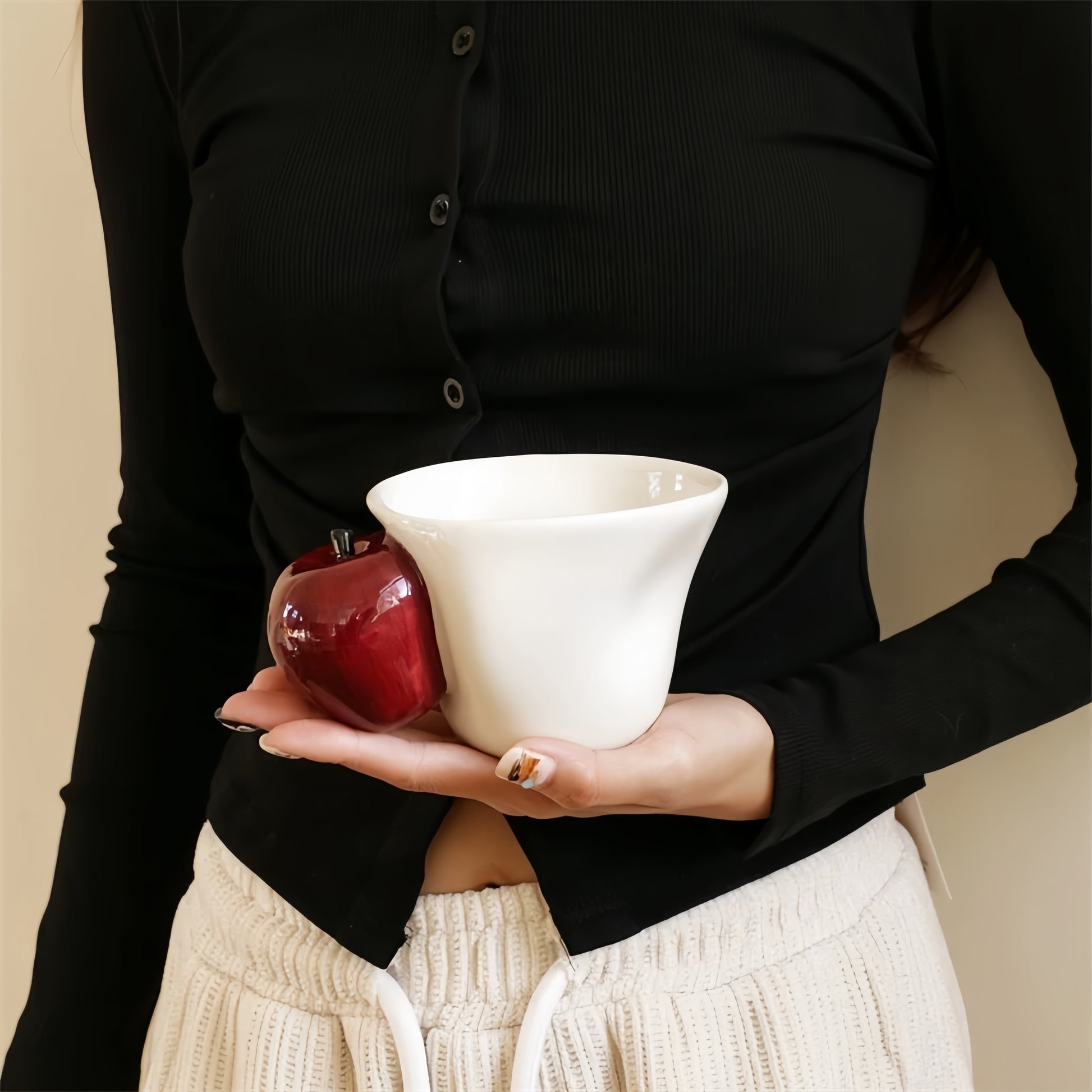 Person holding cup, emphasizing ergonomic design and natural grip.