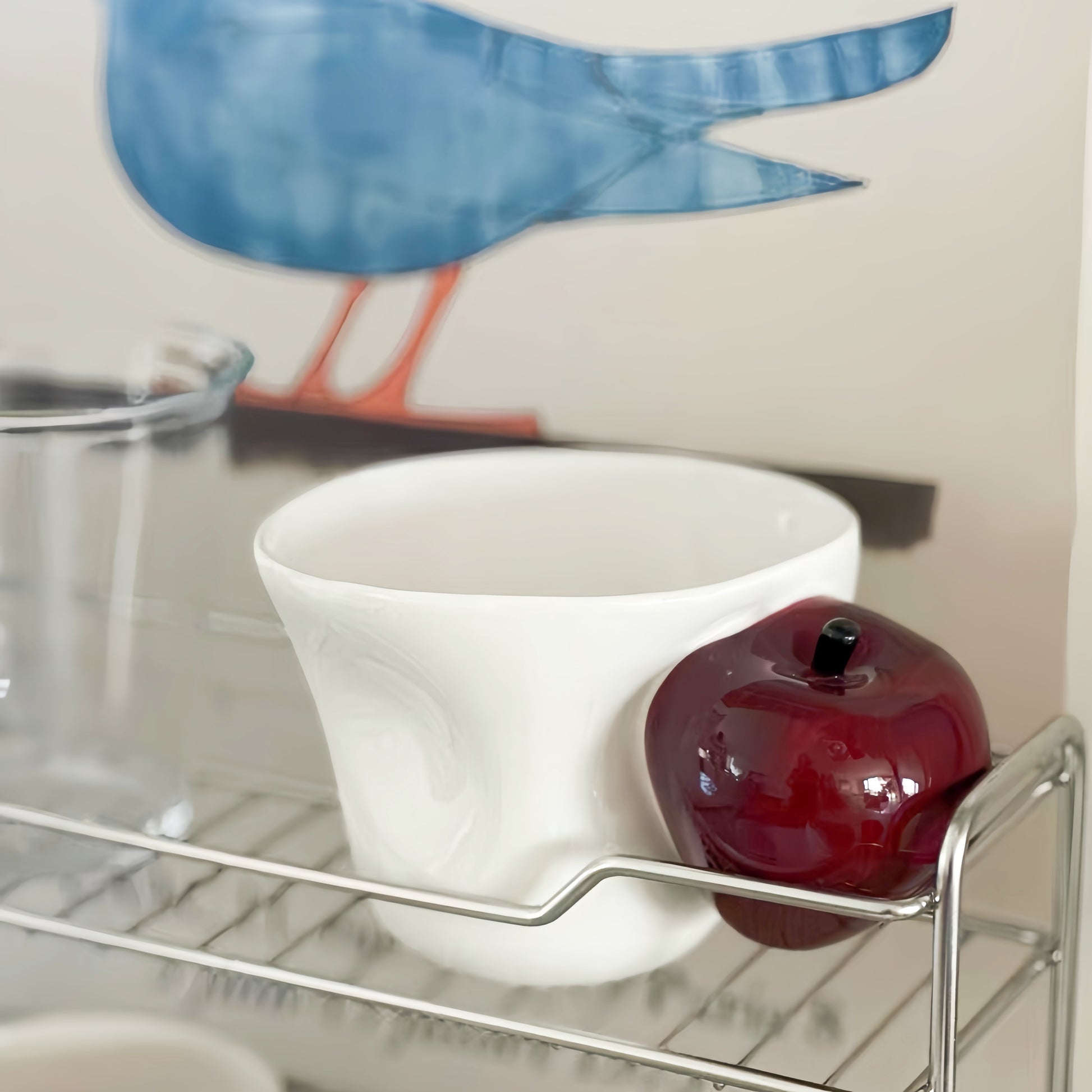 Artisanal apple cup elevating workspace decor on wooden desk.