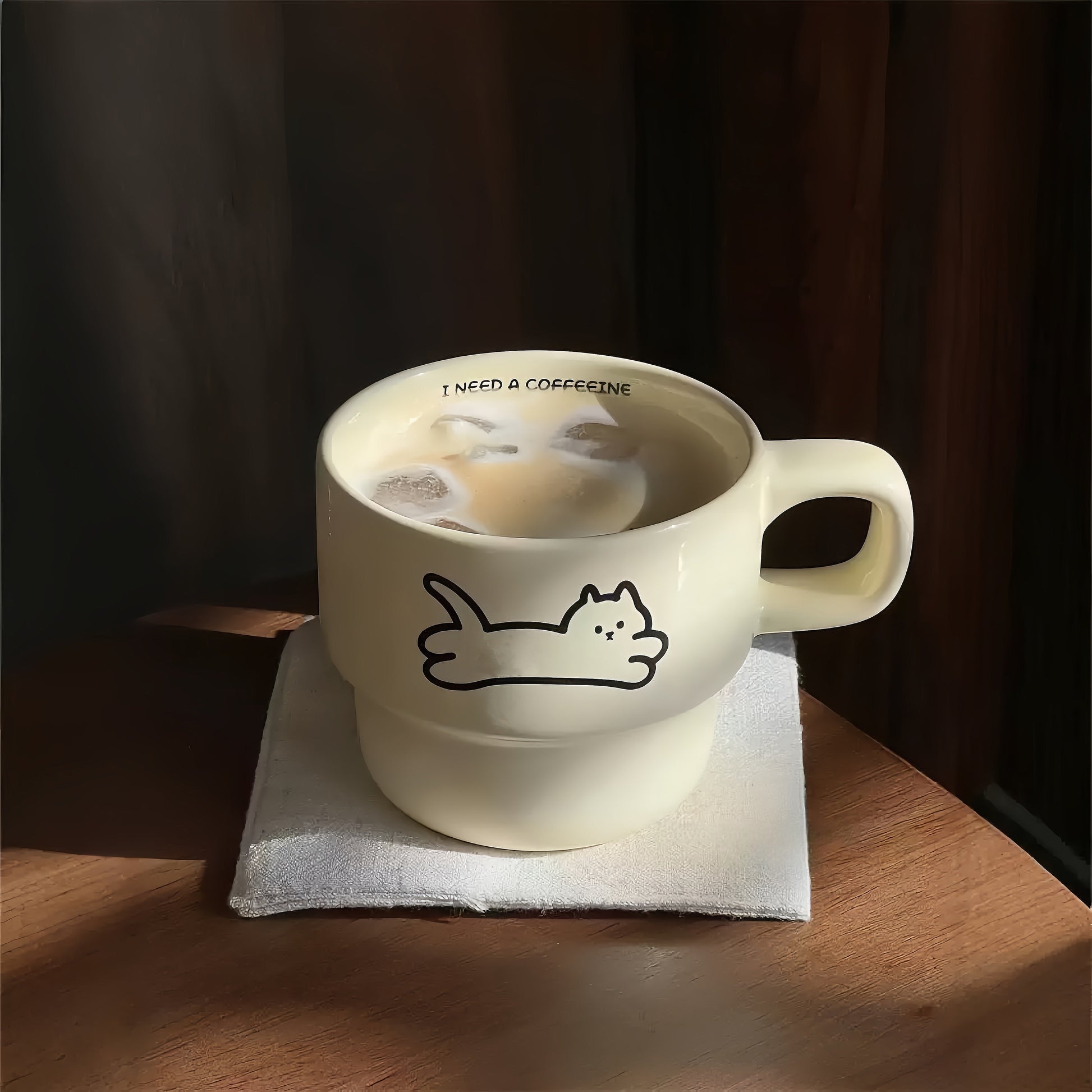 The lazy kitten mug adding a whimsical touch to a cozy kitchen shelf decor.