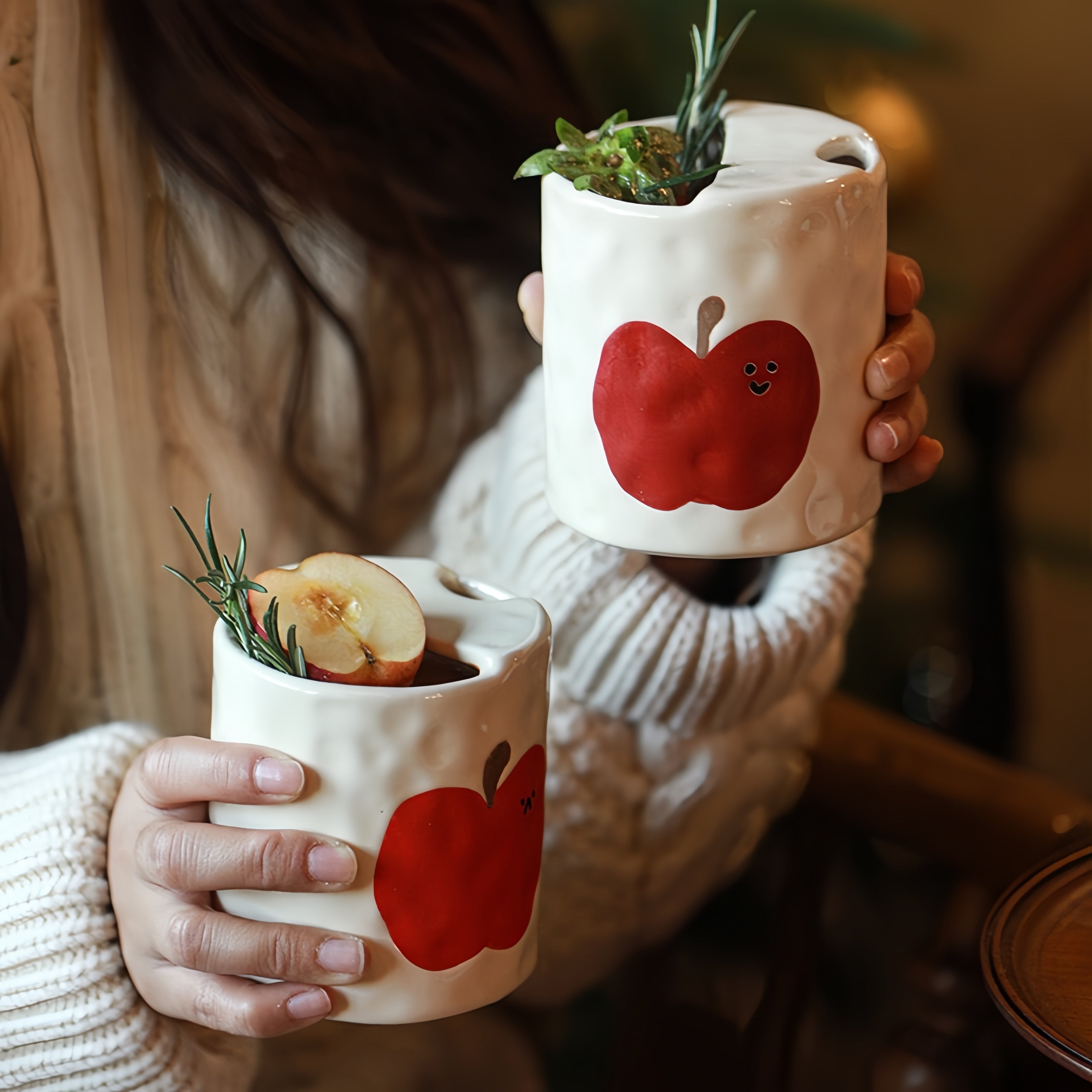 Front view of the handmade Happy Apple ceramic travel mug with a bright, joyful apple motif.