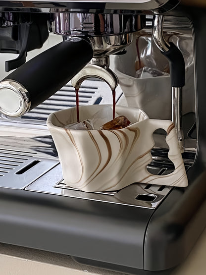 Thick-walled ceramic coffee cup for optimal heat retention and durability.