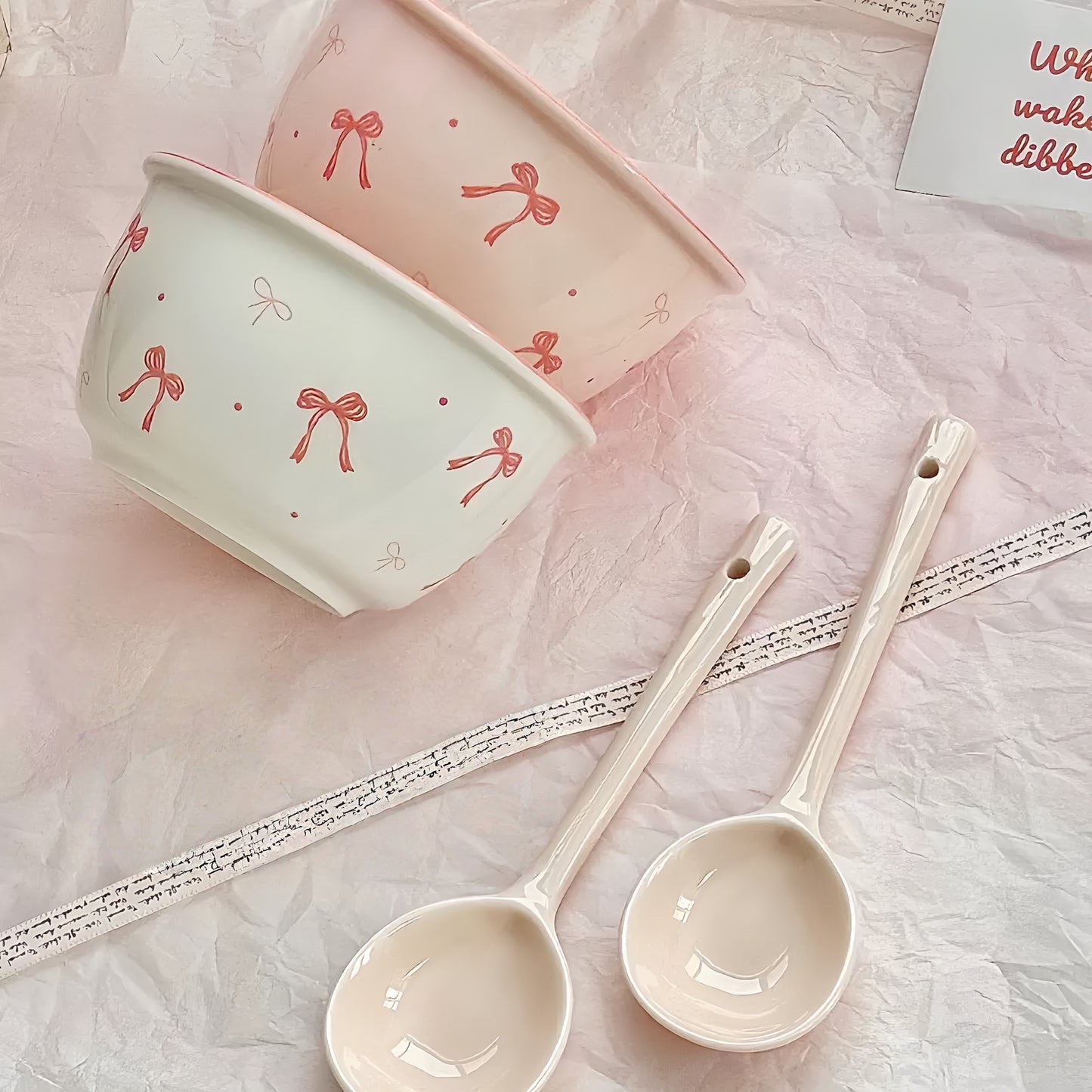 Close-up of ceramic bowl's delicate pink bow decoration - smooth food-safe surface