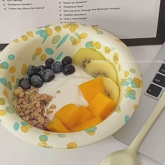 Layers of yogurt, homemade granola, and fresh fruit in a beautiful handmade breakfast bowl.