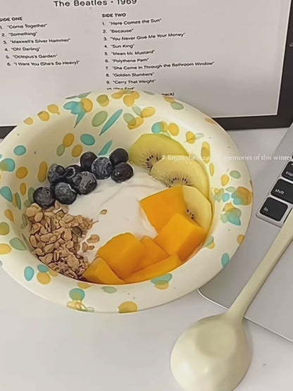 Layers of yogurt, homemade granola, and fresh fruit in a beautiful handmade breakfast bowl.