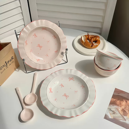 A stack of Princess Bowknot plates in both pink and white base colors.