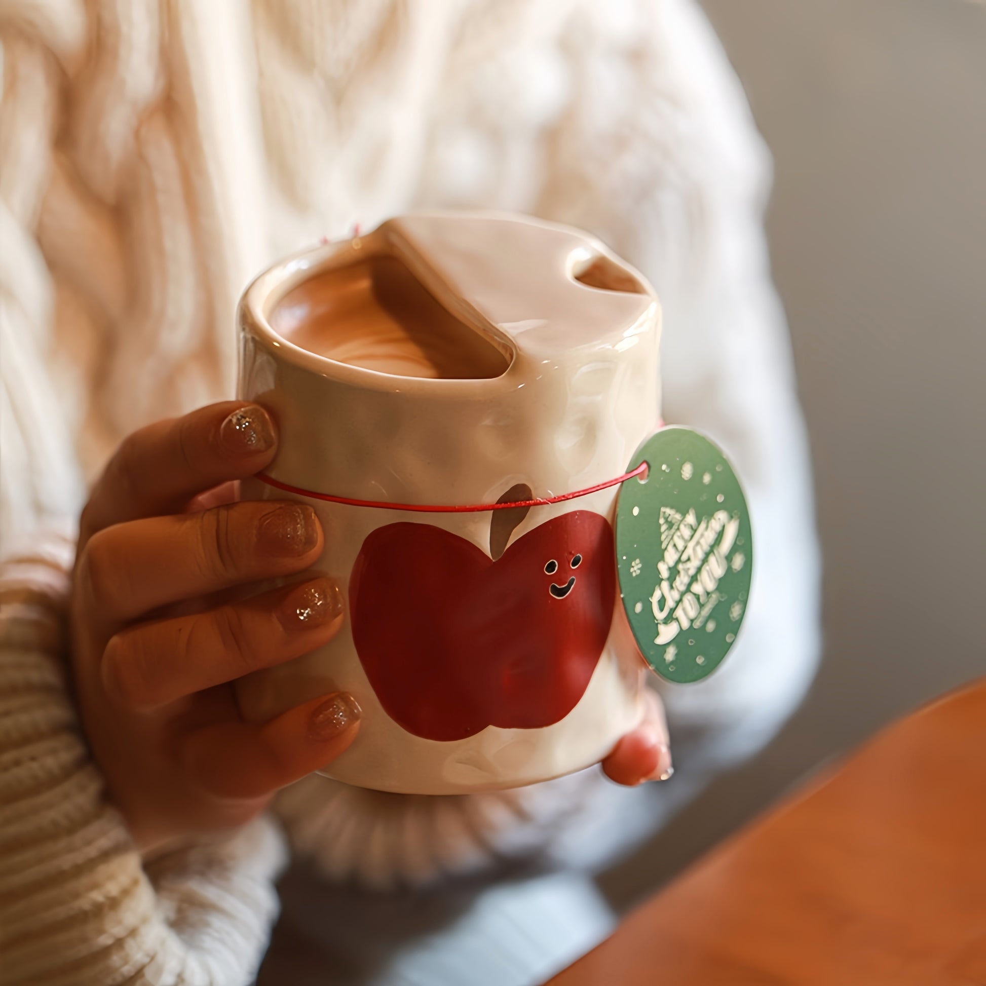 Side profile of the eco-friendly, reusable apple-designed ceramic cup showing its sippy-style shape.
