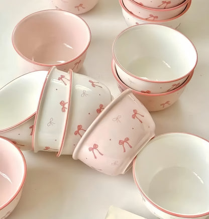 Stacked white and pink ceramic bowls with bow design - space-saving tableware set