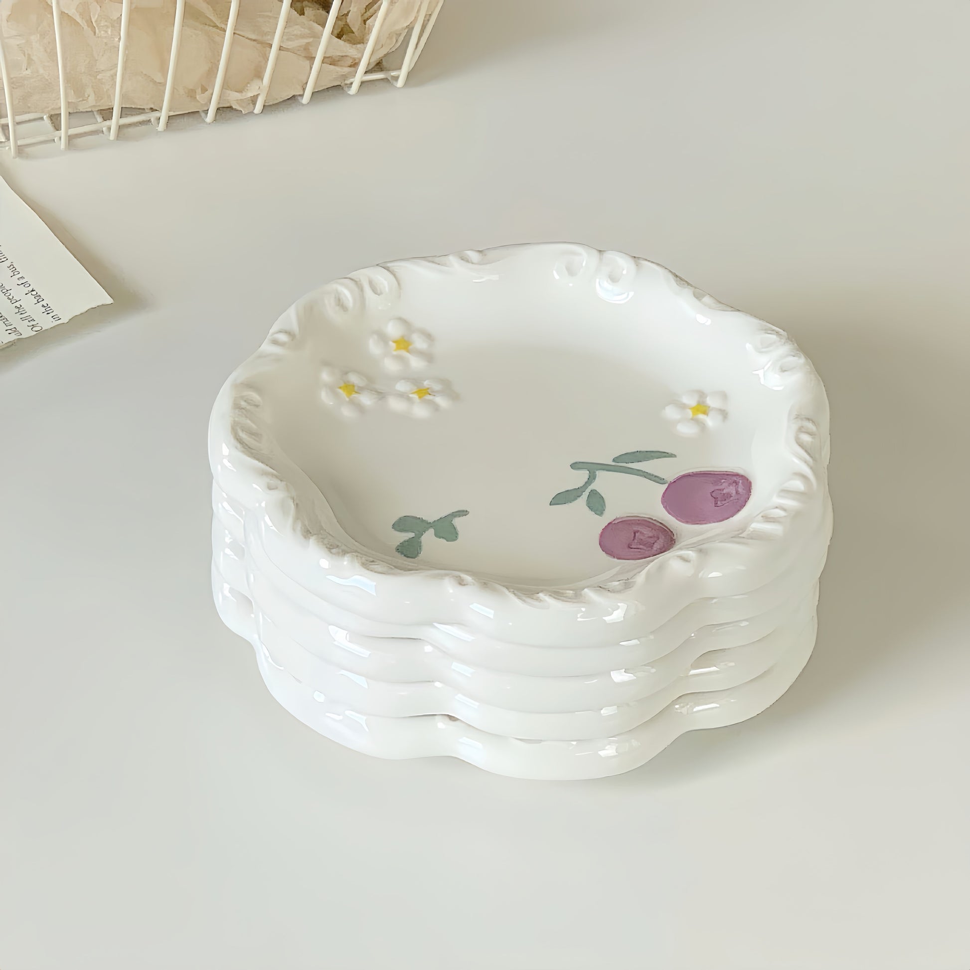 A set of four matching artisan dessert plates stacked together for a beautiful table setting.